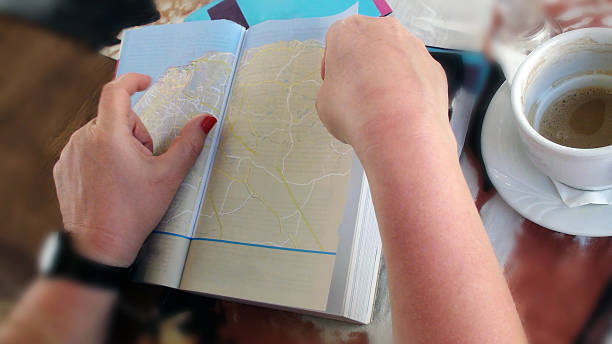 istock Tourist Taking A Break And Reading Book With Map 479986140