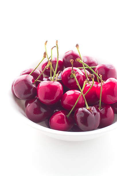 istock Bowl of fresh red cherries on white background 479989684