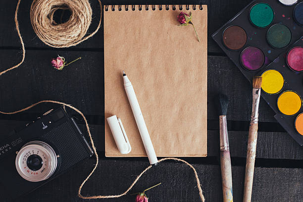 istock Blank paper mockup with artist brushes on wooden table 479989792