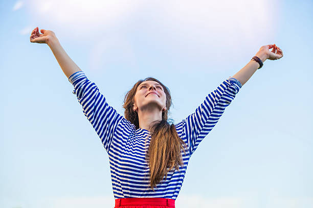 istock Woman pulls hands to the sunlight against the sky 479993712