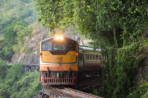 Train moving on railway bridge at Kanchanaburi, Thailand.