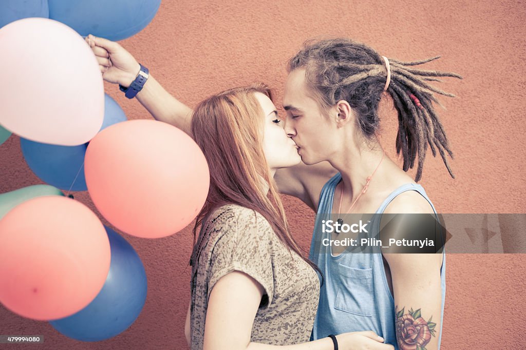 Happy And Funny Couple Kissing At Background Of Color Balloons Stock Photo  - Download Image Now - iStock
