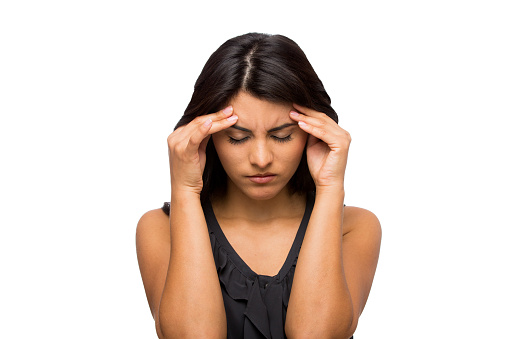 Businesswoman suffering from a headache isolated over white background