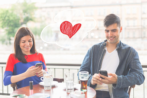 Couple on date in cafe with mobile phones