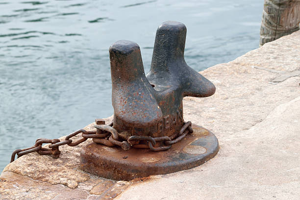 istock Rusted bollard and iron ring and chain. 479998228