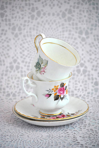 istock antiques flower decorated cup saucer on white crochet background 479998698
