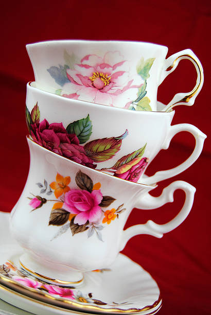 istock antiques flower decorated cup and saucer on red  background 479998706