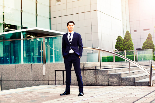 Portrait of japanese businessman in Tokyo, Background is modern business building. Concept for modern business and lifestyle. Image is taken during Tokyo istockalypse 2015.