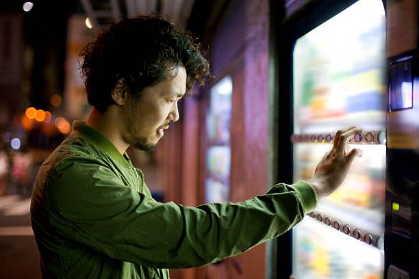istock Young Japanese Man Using Vending Mashine in Tokyo. 480002950