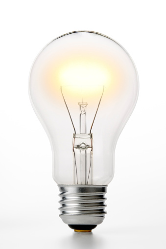 Close up of illuminated light bulb isolated on white background with clipping path.