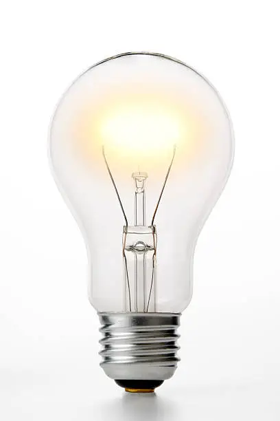 Photo of Isolated shot of illuminated light bulb on white background