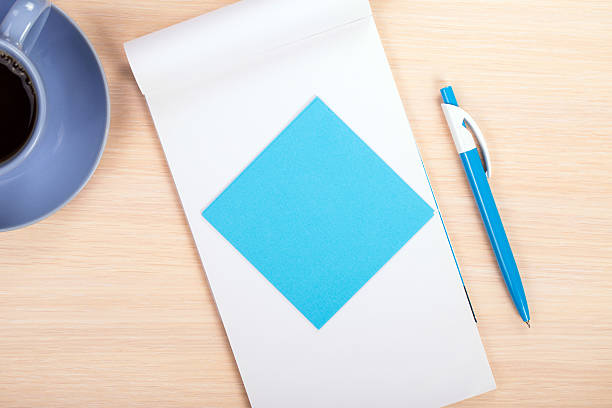istock colored paper with a pen and a cup of coffee 480003764
