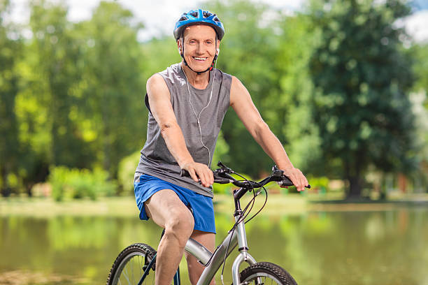 istock Senior biker with a blue helmet posing on his bicycle 480004492
