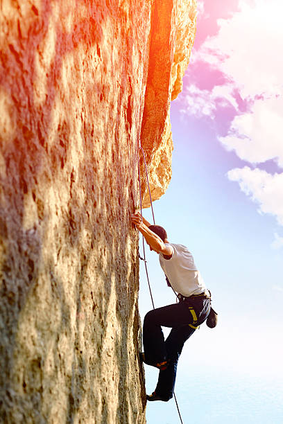 istock Rock climber climbing up a cliff 480005054