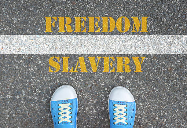 istock Shoes standing at the line between slavery and freedom 480010478