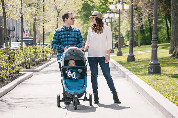 istock young family with baby strollers on city walk 480011106