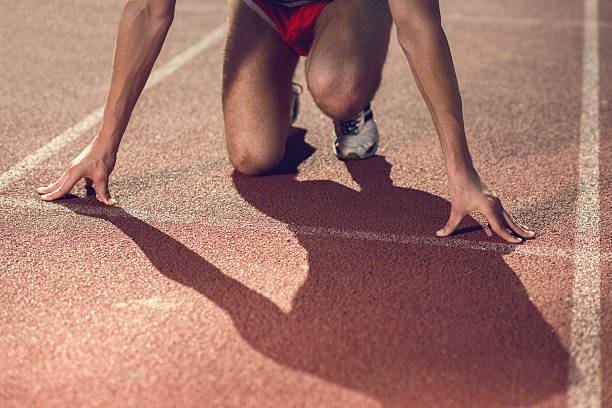 istock Unrecognizable athlete on a starting line at running track. 480026316