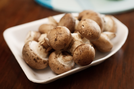 Portobello mushroom on a old vintage table top, Agaricus bisporus