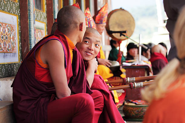 Young monks watching Bhutan festival. stock photo