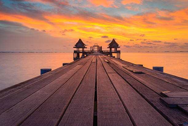 Wooded bridge in the port and sunset