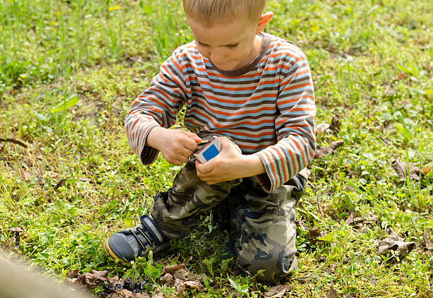 istock Young boy lighting a fire outdoors 480034628