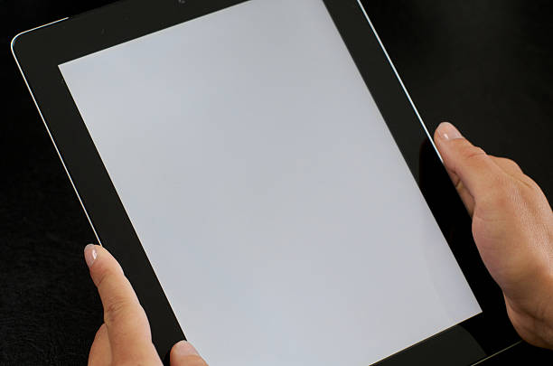 istock Woman holds tablet in both hands - Woman holding tablet 480035978