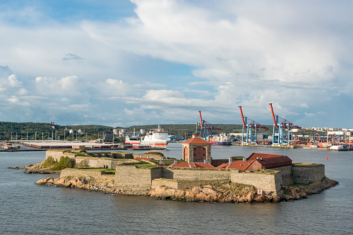 Gothenburg, Sweden - August 24, 2014: Ãlvsborg, also Elfsborg Fortress in front of the port of Gothenburg in Sweden. Ships are moored in port in the background.