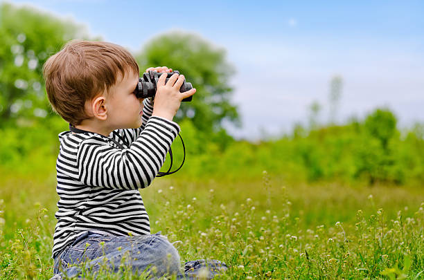 istock Little boy looking at the camera with binoculars 480039368