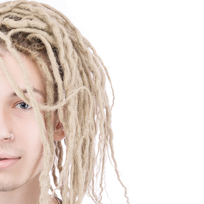 Half face of young adult man with dreadlocks over white background