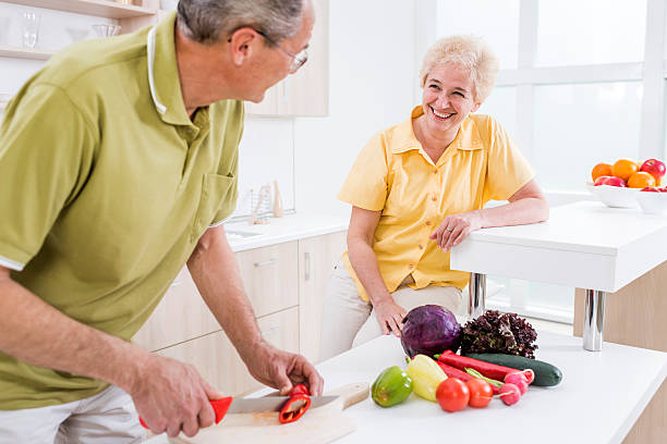 istock Mature couple preparing food and communicating in the kitchen. 480039866
