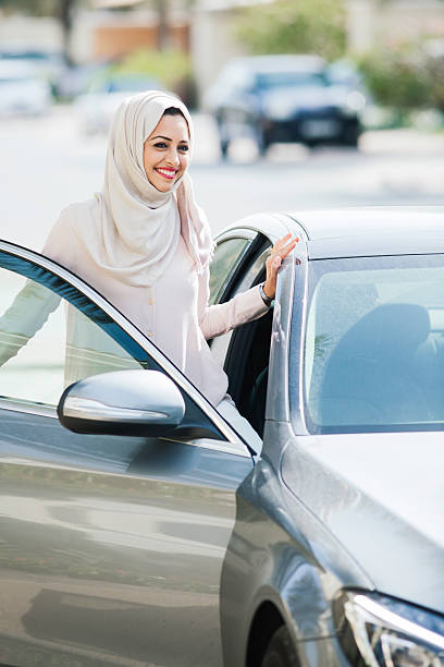 istock Middle easter woman entering a luxury car in Dubai 480040336
