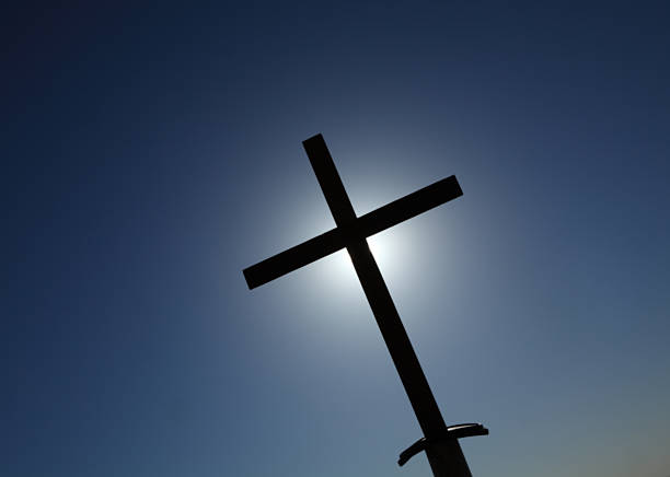 istock Cross silhouette against a dark blue sky 480044040