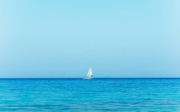 istock Blue sea in summer time with yacht on horizon 480044182