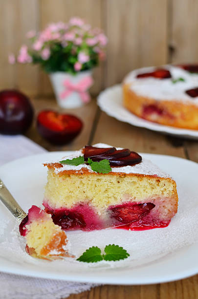 istock Plum cake on wooden table 480044552