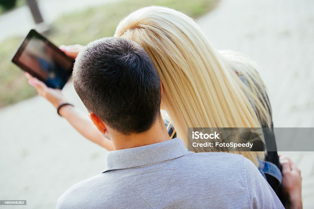 Couple Using Taking Selfie Young Couple In Park Taking Selfie 20-29 Years Stock Photo