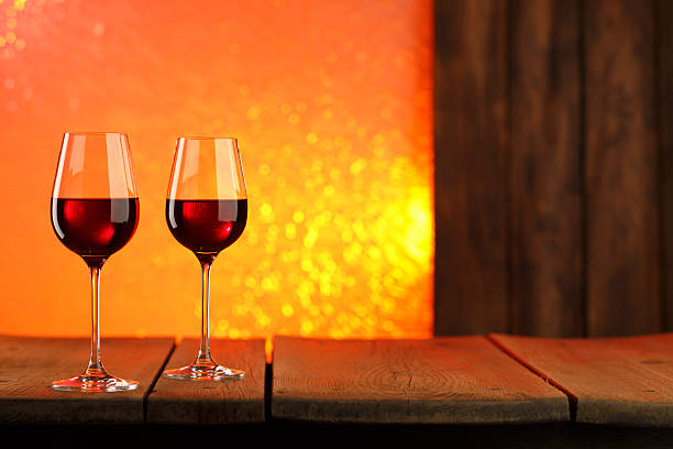 Close up photo of human hands toasting with red wine, selective focus