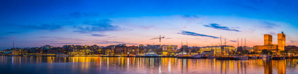 istock Oslo Aker Brygge harbour waterfront landmarks illuminated sunset panorama Norway 480048838