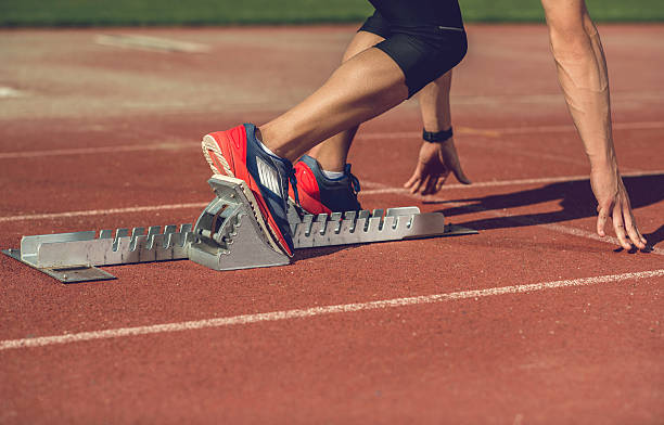 istock Unrecognizable man preparing to start a race on running track. 480049004