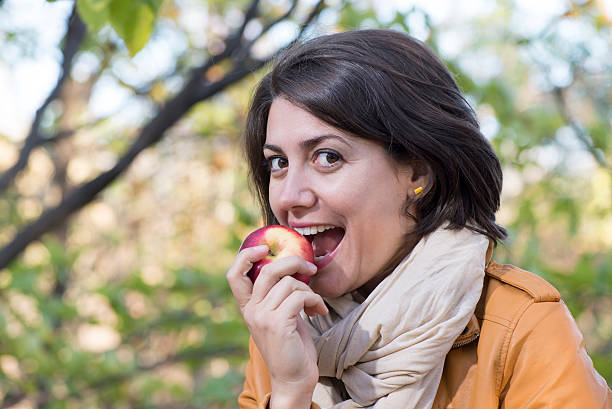 istock Young woman biting the red apple 480062463