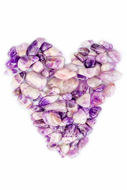 istock Amethyst quartz stones in a heart shape layout 480062654