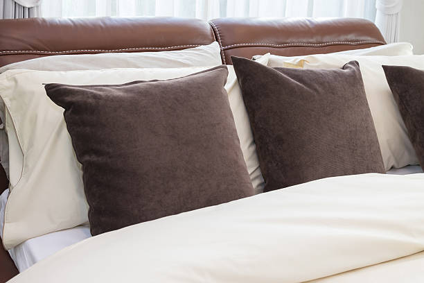 istock modern bedroom with brown pillows and lamp 480066612