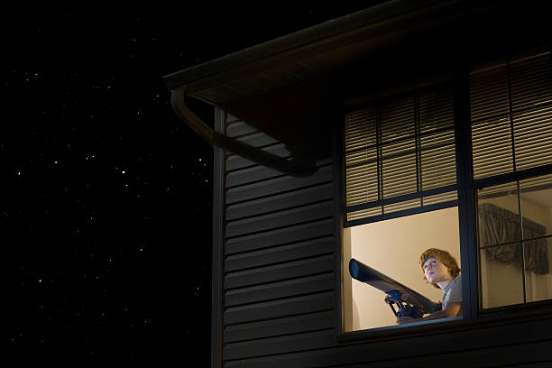 istock Boy With Telescope Looking At Night Sky 480070571