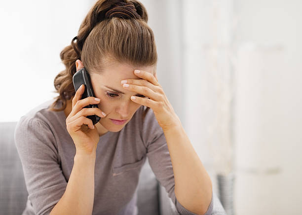 istock stressed young woman talking cell phone 480082259