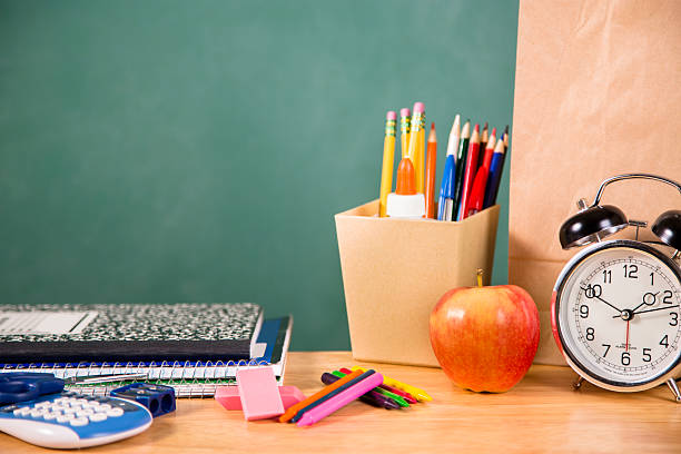 istock Back to school. School supplies, apple, clock on desk. Education. 480082896