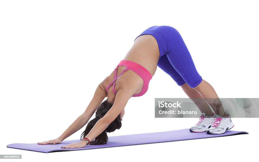 Downward facing dog Drop your head so that your neck is long, wrist creases stay parallel to the front edge of the mat. Press into the knuckles of your forefinger and thumbs to alleviate pressure from your wrists. Breathe here for at least three deep breaths. 2015 Stock Photo