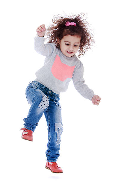 istock Fun little curly girl fun jumps 480089744