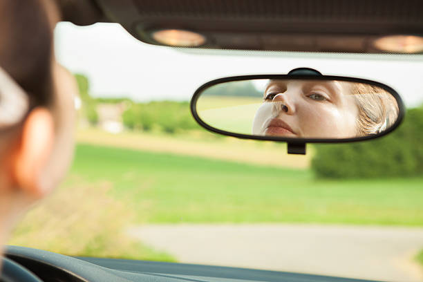 istock Woman Looking At Mirror In Car 480091463