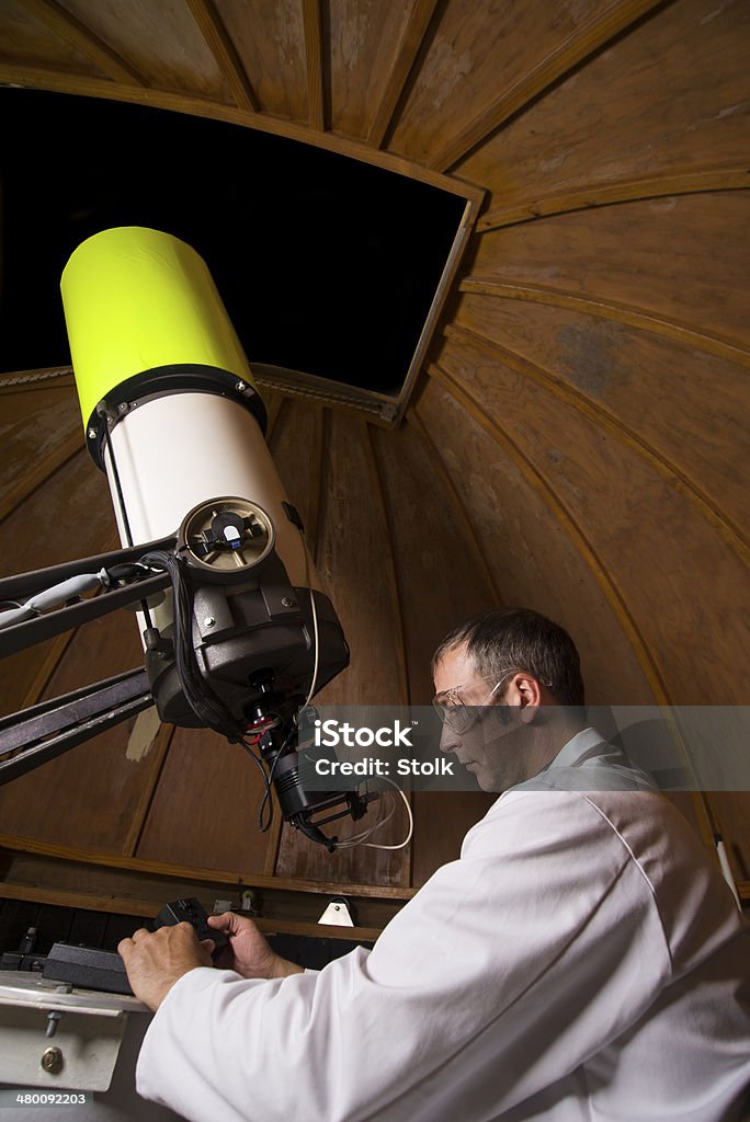 Astronomer A Caucasian scientist working with a a large telescope Astronomer Stock Photo