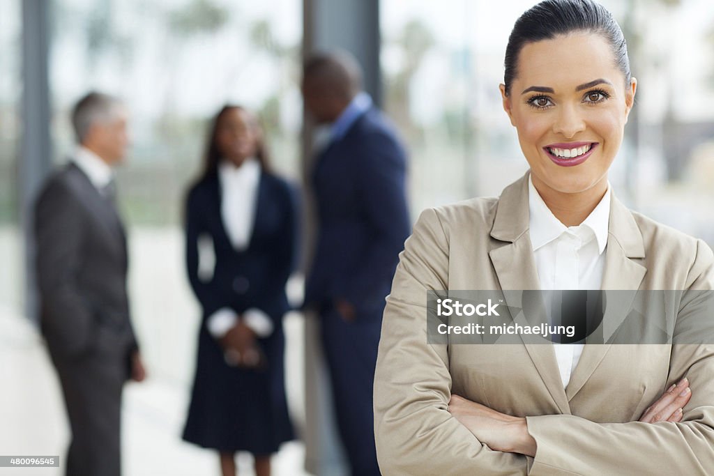 attractive business executive attractive business executive with arms folded in office Adult Stock Photo
