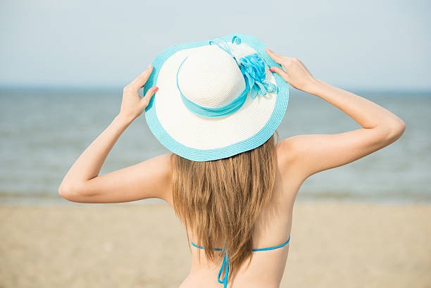istock Young lady sunbathing on a beach. Beautiful woman posing at 480098474